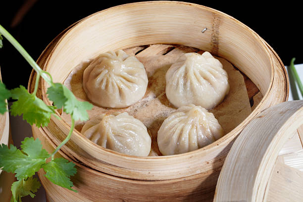 istock Chinese dumplings wooden steamer still life on a table the 509411202