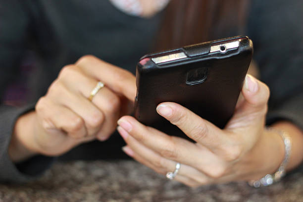 istock Close up of a woman using mobile smart phone 509414646
