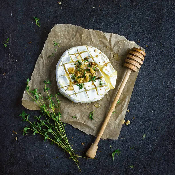 baked camembert cheese with  nuts and honey, top view, square image