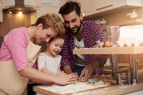 istock Kid loves spending time with her parents in the kitchen 509415696