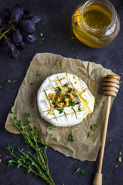 cocido camembert queso con tuercas y miel - honey roasted nut fotografías e imágenes de stock