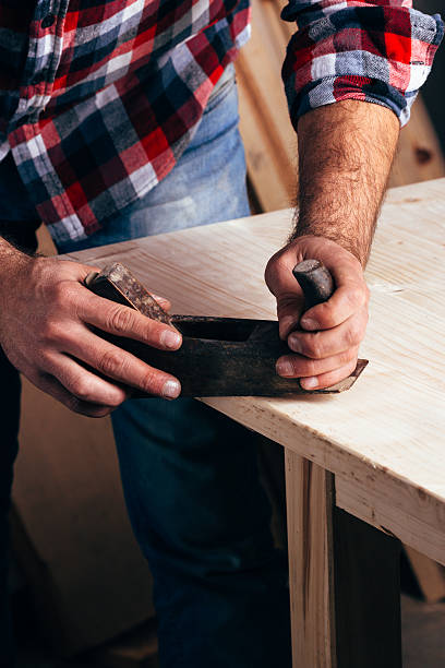 istock Hands of a carpenter planed wood, workplace 509416394
