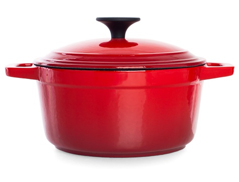 Red cast iron cooking pot with black handle, isolated on white background.