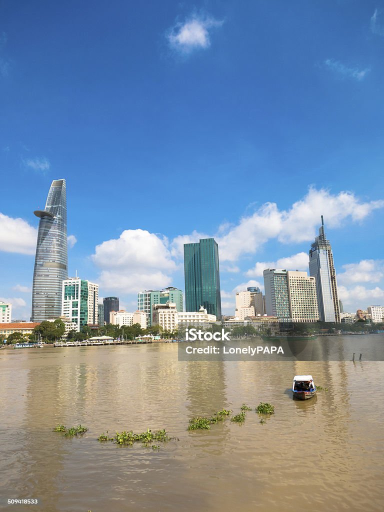 Skyscraper of Ho Chi Minh City, Vietnam Skyscraper and Saigon River of Ho Chi Minh City, Vietnam under blue sky. Variation with boat on the Saigon River. Ho Chi Minh City Stock Photo