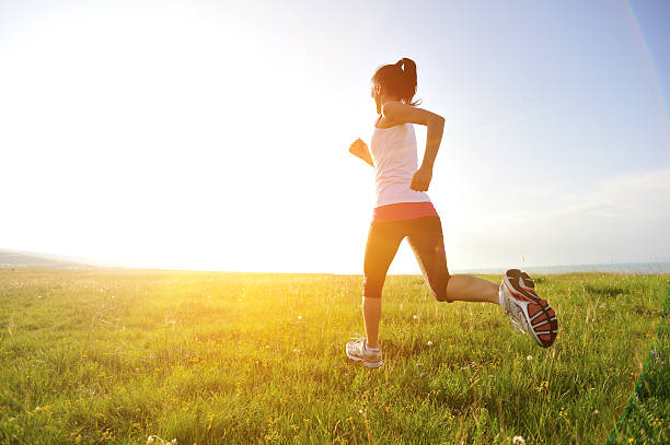istock Runner athlete running on sunrise/sunset grass field 509418953