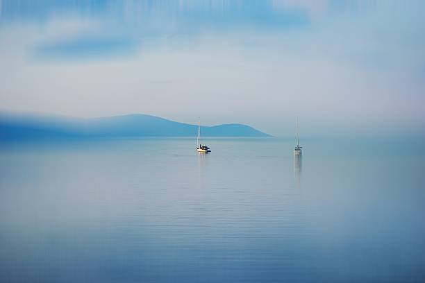 istock Mimalist concept: boat on the quiet blue sea 509419389