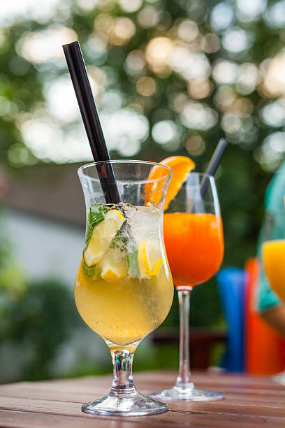 istock Cold, refreshing and colorful drinks with straws on wooden table 509419638