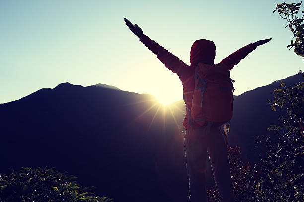 istock successful woman hiker open arms on sunrise mountain peak 509419704