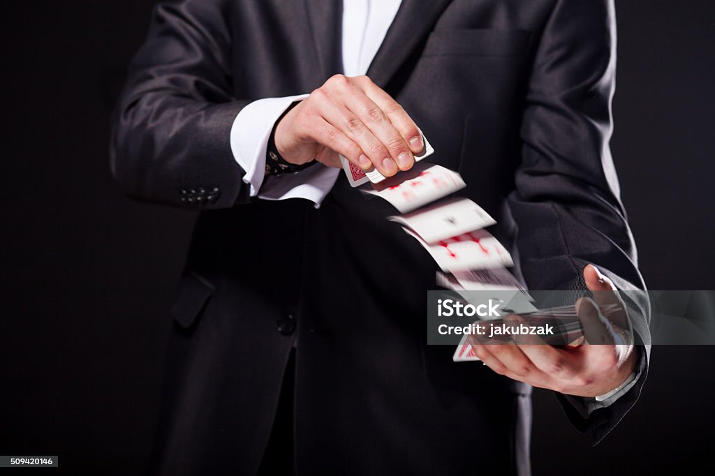 Young magician showing tricks using cards from deck. Close up. Young magician showing tricks using cards from deck. Close up Magic Trick Stock Photo