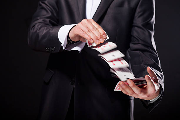 Young magician showing tricks using cards from deck. Close up. Young magician showing tricks using cards from deck. Close up magic trick photos stock pictures, royalty-free photos & images
