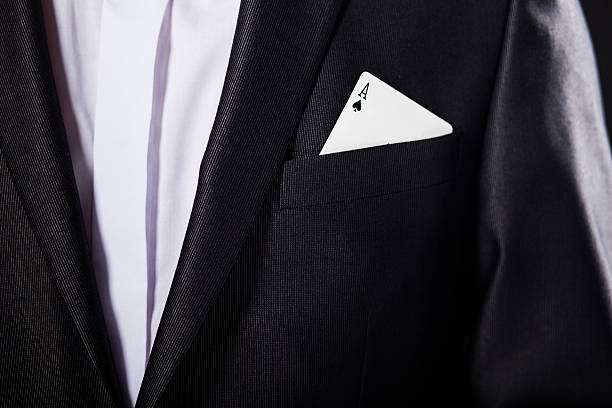 Young magician showing tricks using cards from deck. Close up. stock photo