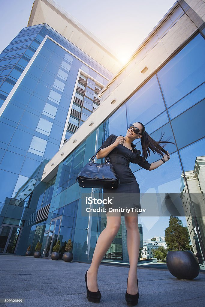 beautiful woman walking in the city Business woman walking outside in city. office worker Businesswoman Stock Photo