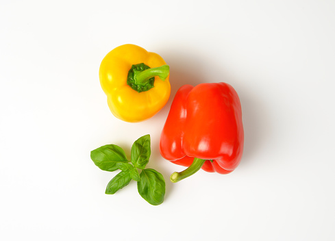 yellow and red bell peppers on white background