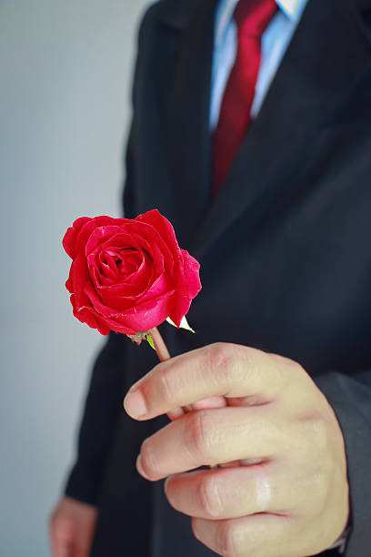istock Business man in suit showing rose 509423172