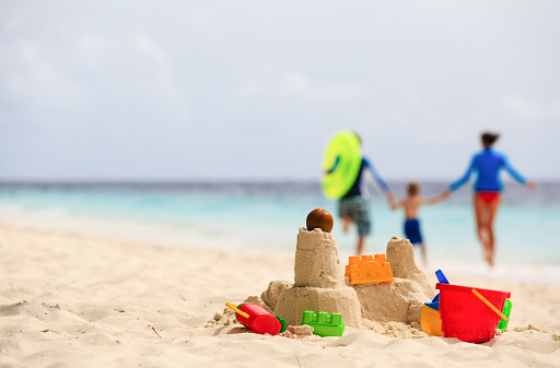 sand castle on tropical beach, family vacation concept