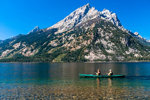 Jackson, Wyoming, USA - September 12, 2009: People kayaking beautiful Jenny Lake in the remote Grand Tetons of Wyoming.