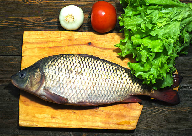 istock raw fish on wooden table as background 509428008
