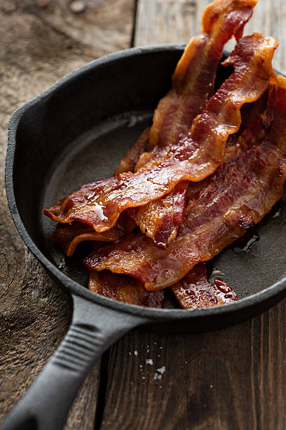 istock Sizzling hot bacon in a cast iron skillet 509428944