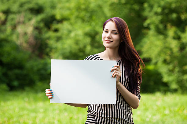 istock Woman holding blank board 509429128