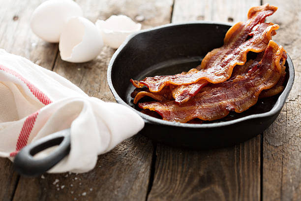 istock Sizzling hot bacon in a cast iron skillet 509429382
