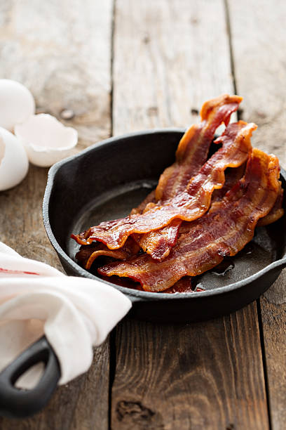 istock Sizzling hot bacon in a cast iron skillet 509429530