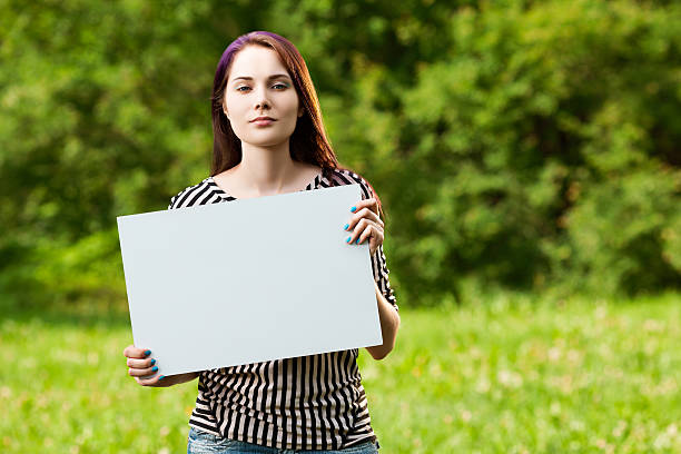 istock Woman holding blank banner 509429854