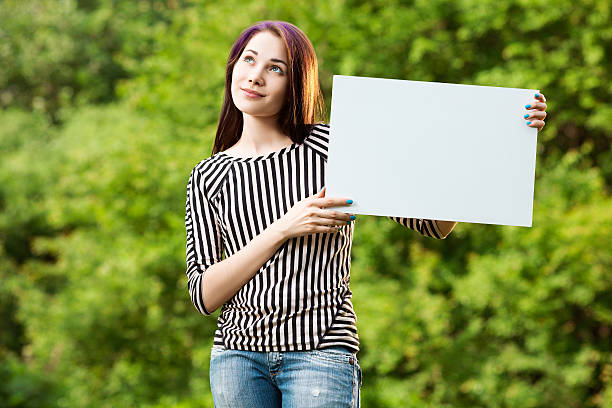 istock Woman holding blank banner 509430640