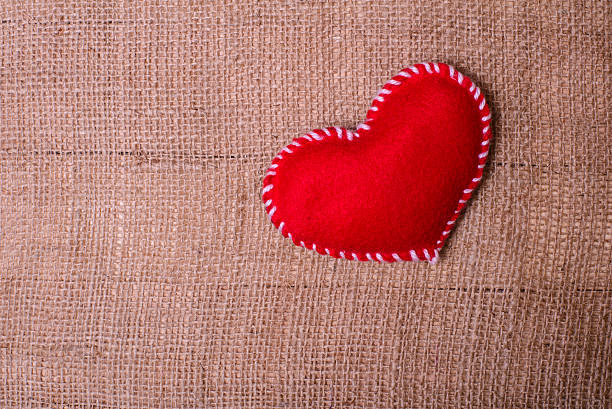 istock Textile heart on fabric texture of burlap 509433252