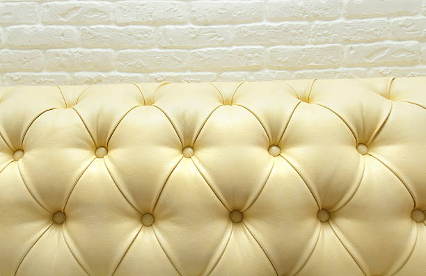 istock Leather upholstery of a magnificent sofa,decorative brick masonr 509433504