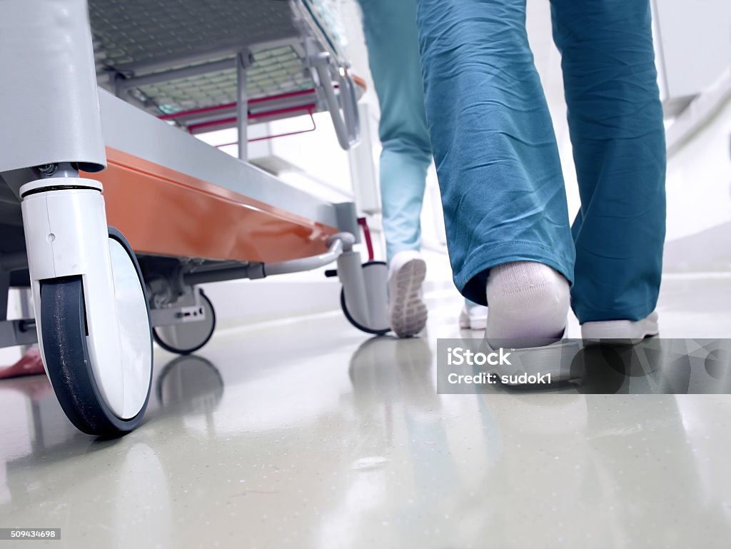 Medical staff moving patient through hospital corridor Hospital Stock Photo