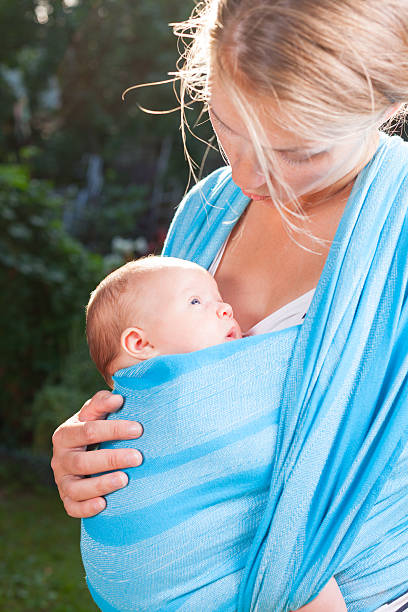 istock Mother with newborn baby in sling 509436780