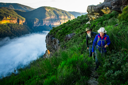 A senior couple hiking in the Australia outback. Blue Mountains National Park.