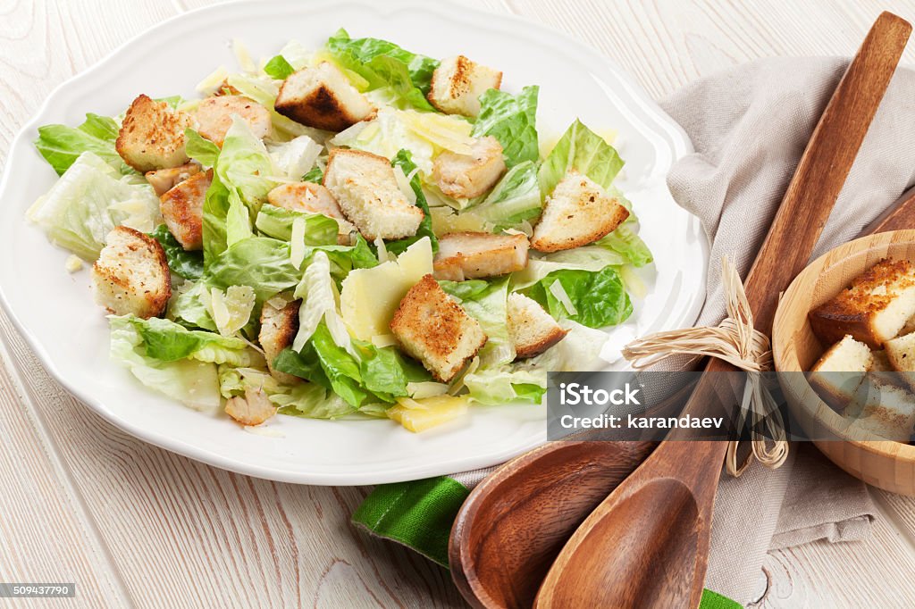 Fresh healthy caesar salad Fresh healthy caesar salad on wooden table Caesar Salad Stock Photo