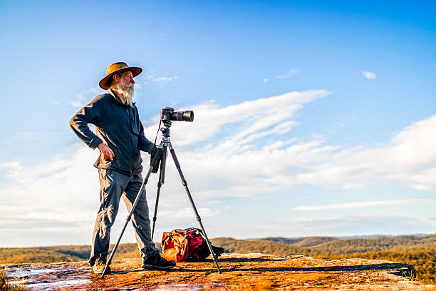 Senior Photographer in the Australia outback. Photographer with camera and tripod on a ridge in the Australia outback, Blue Mountains National Park. Australia outback photos stock pictures, royalty-free photos & images