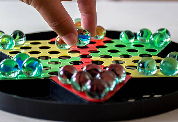 istock hand picking up glass ball checker chess 509438668