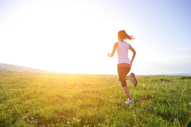 istock Runner athlete running on sunrise/sunset grass field 509441591