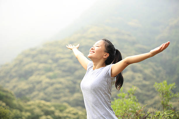 istock cheering hiking woman open arms at mountain peak 509442027