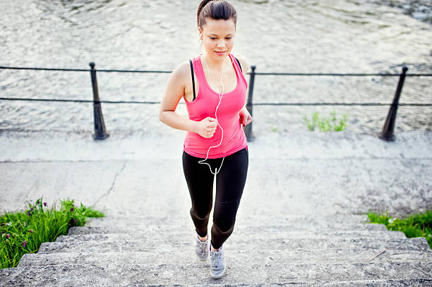 istock Female athlete jogging and training on street, stairs 509463871