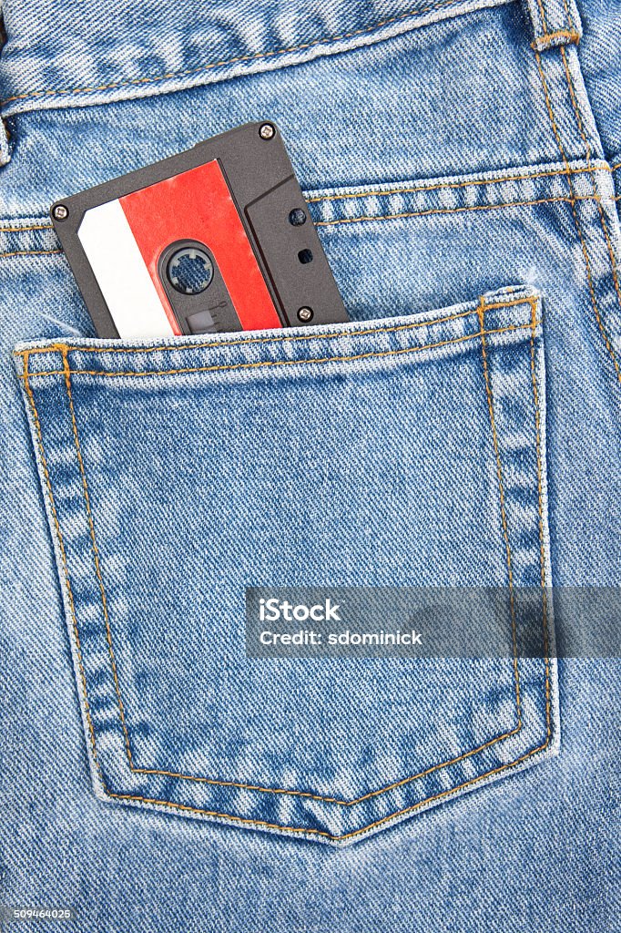 Cassette Tape In Jeans Pocket A cassette tape in the back pocket of a pair of blue jeans. Mixtape Stock Photo