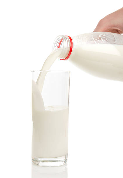 istock Bottle pouring milk into a glass. 509464225