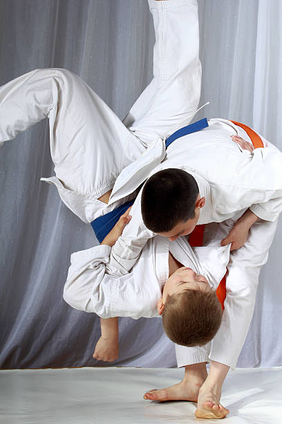 istock Boys in judogi are training throwing 509465271
