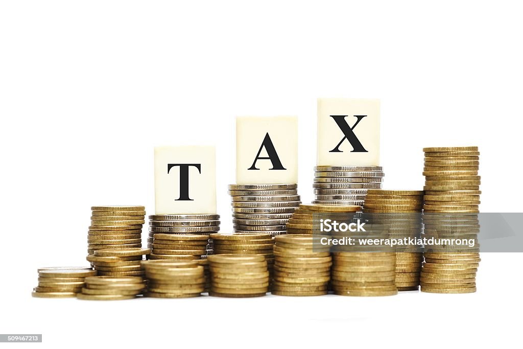 tax Paying tax - a pile of coins with the word tax British Currency Stock Photo