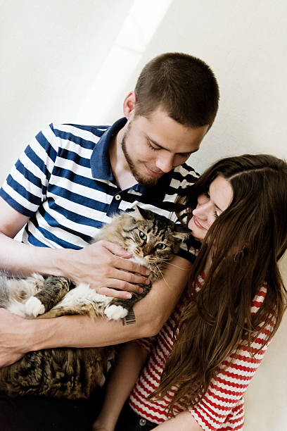 istock happy young couple with their cat 509467569