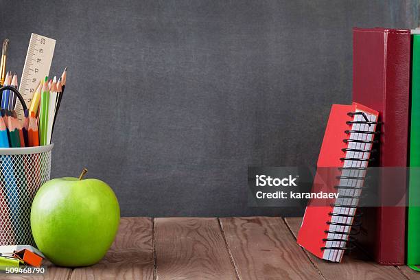 School And Office Supplies And Apple Stock Photo - Download Image Now - Chalkboard - Visual Aid, Book, Desk