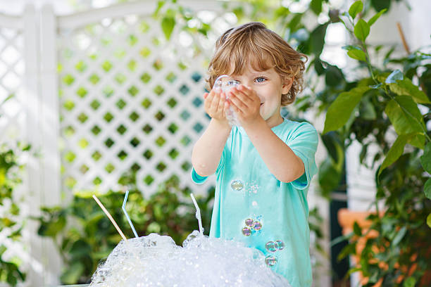 istock Happy little boy making experiment with colorful water and soap 509469085