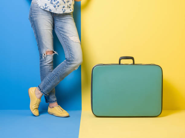 istock Woman stands beside suitcase 509469136