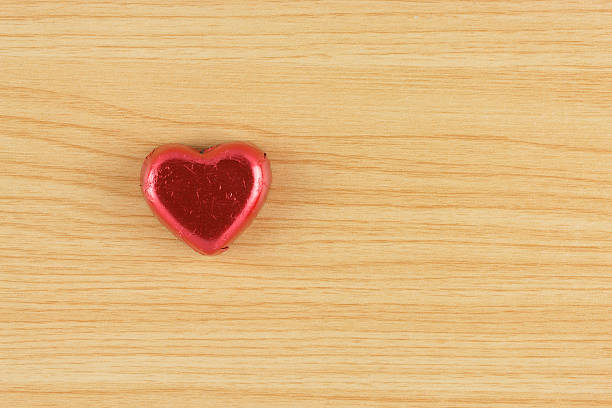 istock chocolate candy red heart on wooden background. 509469306