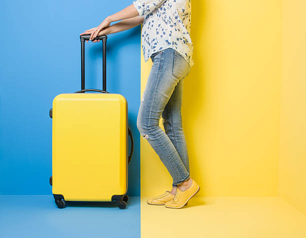 istock Woman stands beside suitcase 509469386