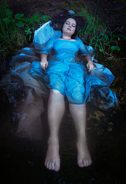 istock Young beautiful drowned woman lying in the water 509469409