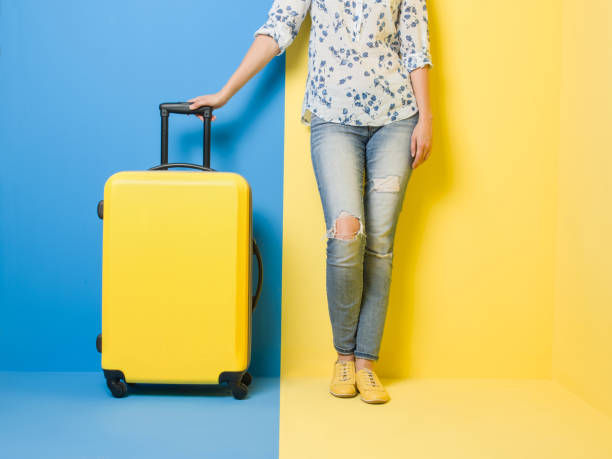 istock Woman stands beside suitcase 509469518